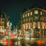 street photography of roads between buildings at night